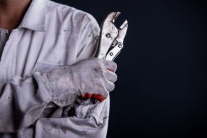 Car Mechanic Wearing White Uniform Stand Holding Wrench (1)